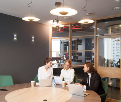 Businesspeople having discussion at team meeting in modern offic